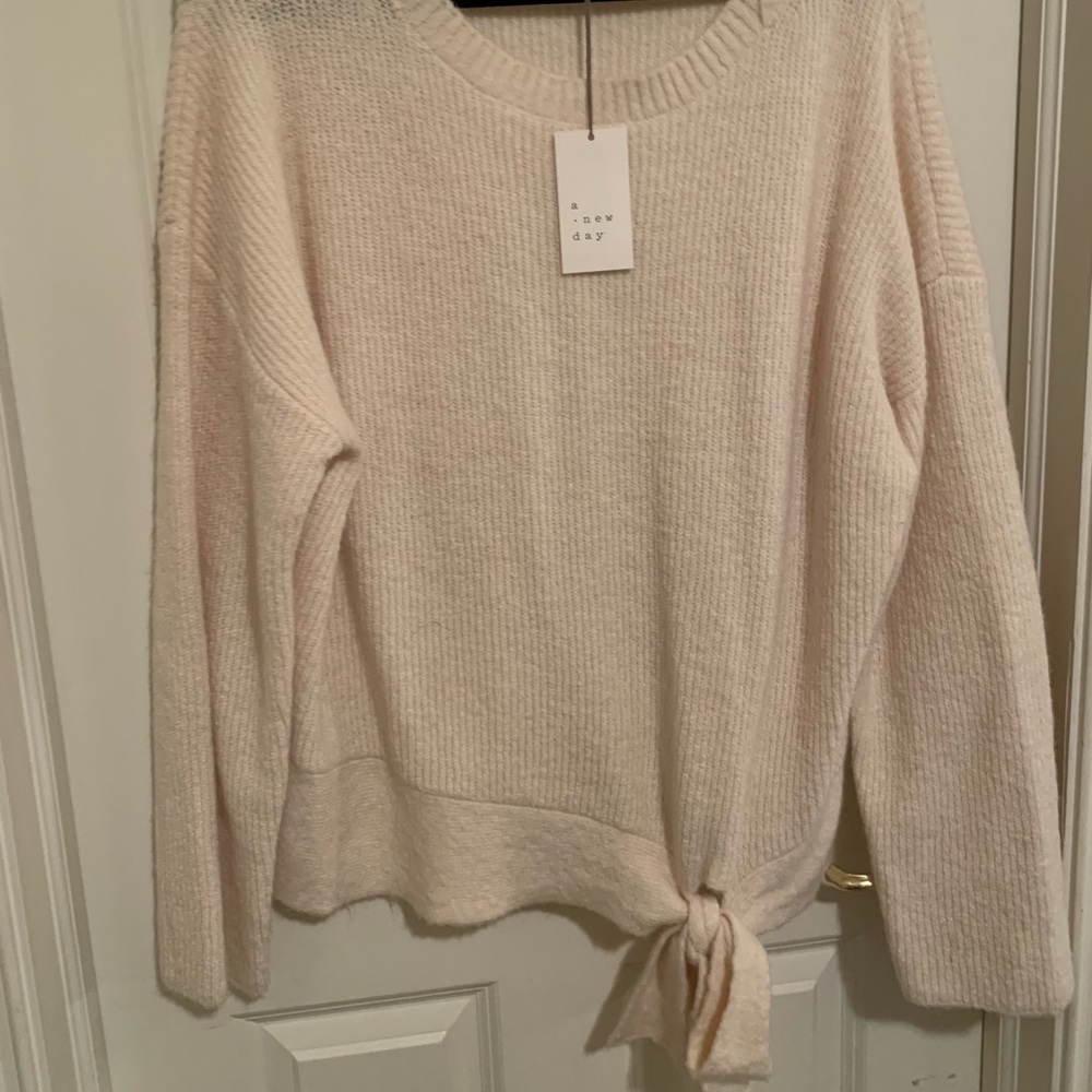 Feminine fuzzy sweater with super cute tie around the border